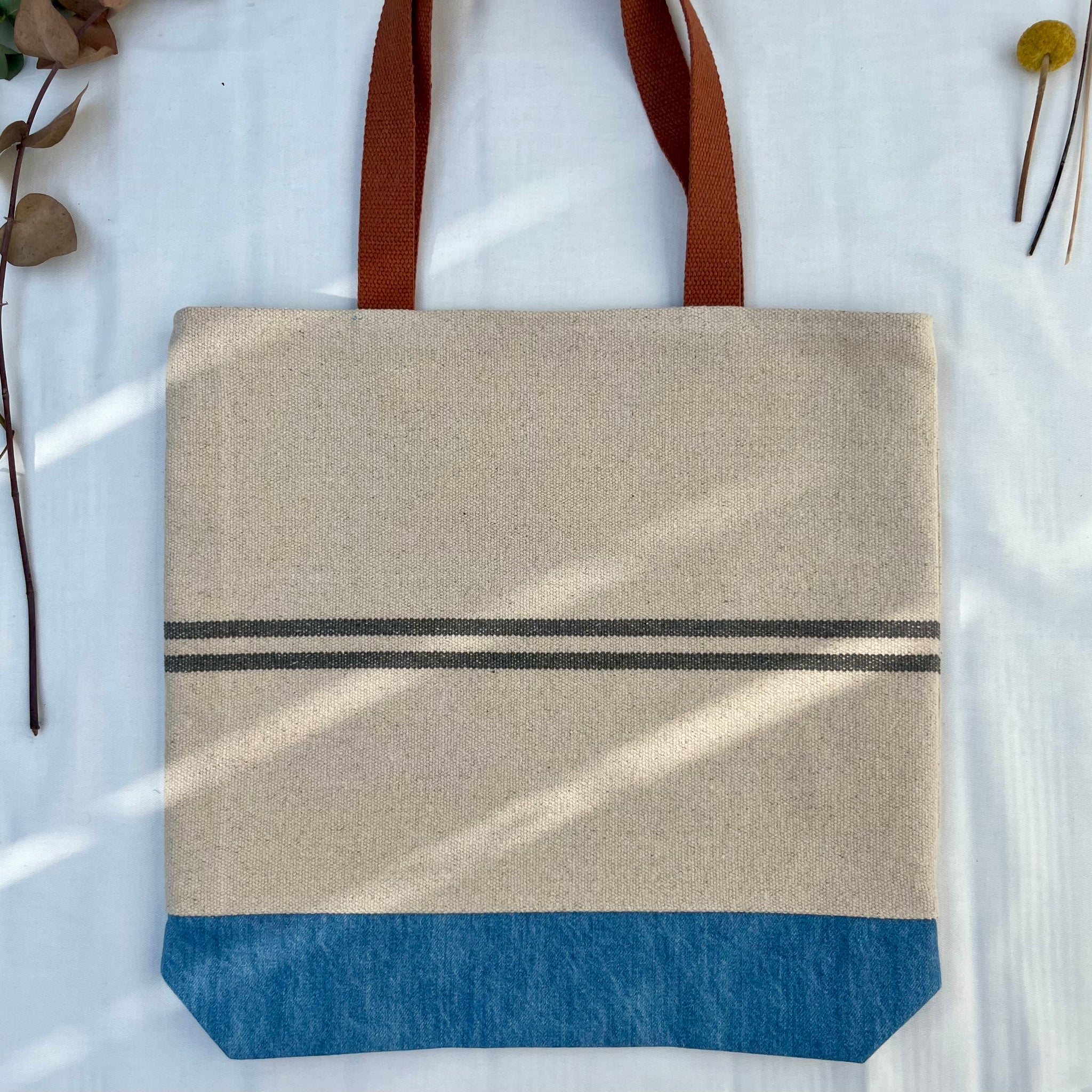 Tote bag. Heavyweight natural woven canvas with two horizontal blue grey stripes and light blue cotton denim bottom